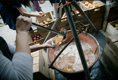 Cider is ladled out to order from a cauldron