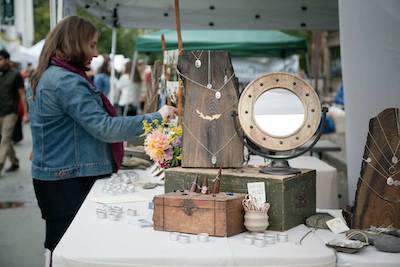 A vendor sells jewelry and other homemade goods